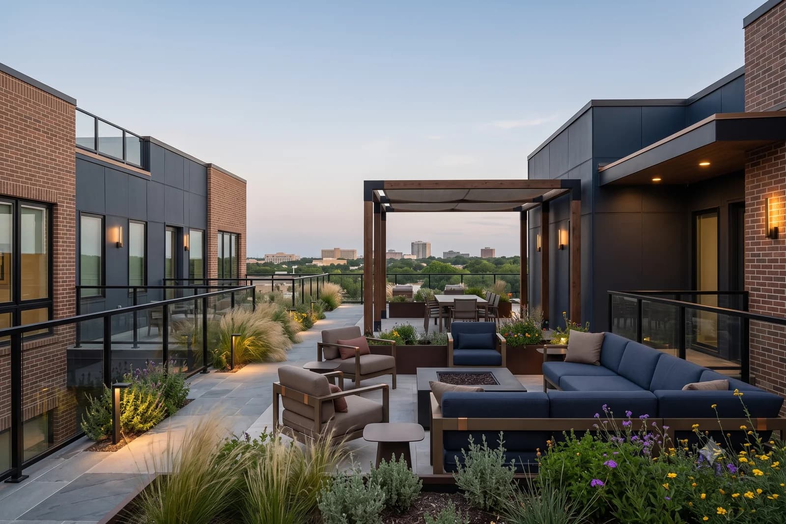A rooftop terrace with a timber pergola, a sectional around a fire table and planted beds, low buildings on the horizon beyond the railing